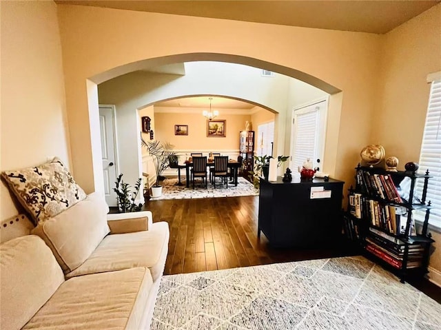 2579 Wimberley Pine Ct, Dacula, GA 30019 - living room with arched walkways, hardwood / wood-style floors, and a chandelier