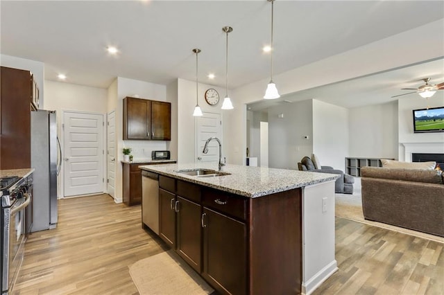 115 Copeland Bnd, Jasper, GA 30143 - kitchen with a sink, stainless steel appliances, light wood finished floors, light stone countertops, and decorative light fixtures