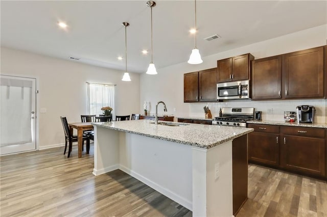 115 Copeland Bnd, Jasper, GA 30143 - kitchen with appliances with stainless steel finishes, a sink, light wood-style flooring, tasteful backsplash, and recessed lighting