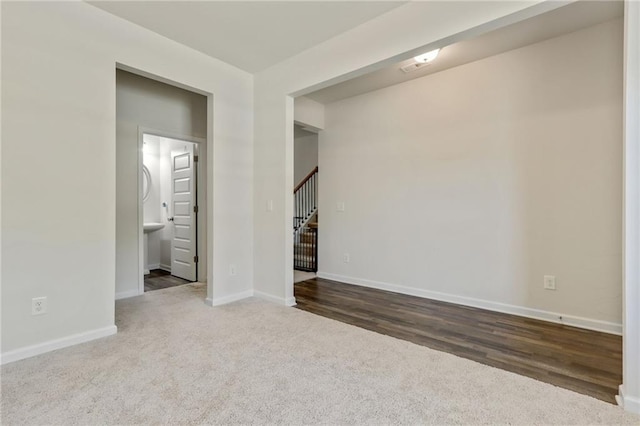 115 Copeland Bnd, Jasper, GA 30143 - spare room featuring carpet flooring, baseboards, stairs, and wood finished floors