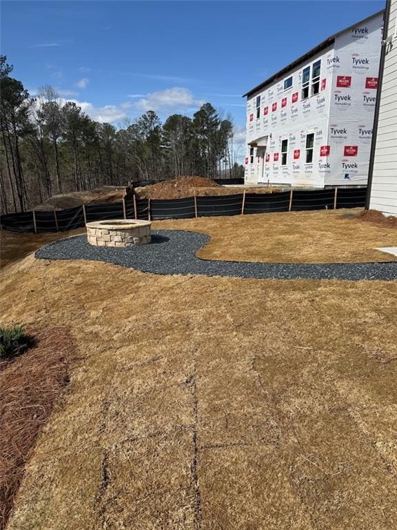 view of yard with an outdoor fire pit