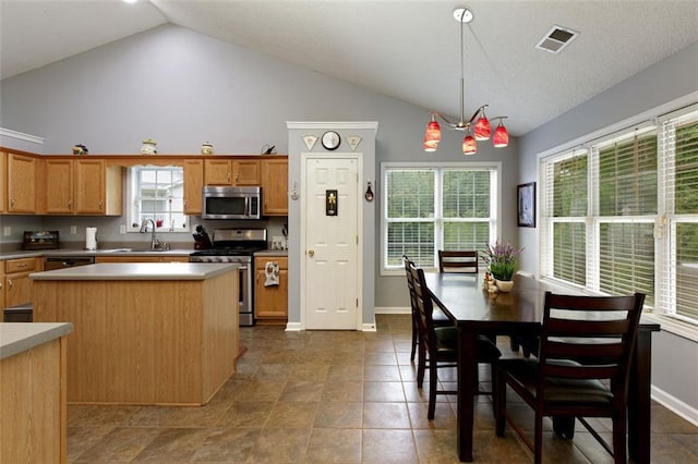 175 Prince Ct, Hiram, GA 30141 - kitchen featuring stainless steel appliances, a sink, a center island, light countertops, and hanging light fixtures