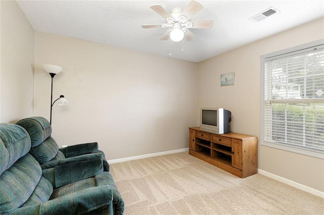 175 Prince Ct, Hiram, GA 30141 - living area featuring light carpet, a ceiling fan, and baseboards