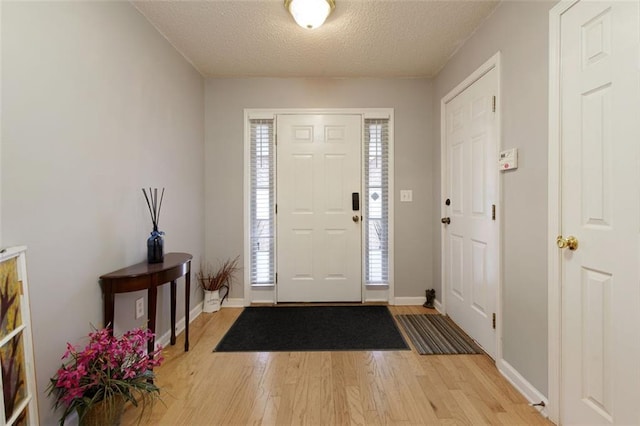 175 Prince Ct, Hiram, GA 30141 - foyer featuring light wood-style floors, baseboards, and a textured ceiling