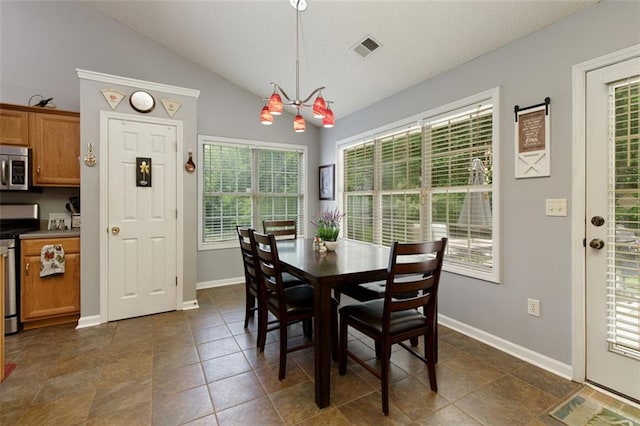175 Prince Ct, Hiram, GA 30141 - dining room featuring lofted ceiling, baseboards, and dark tile patterned flooring
