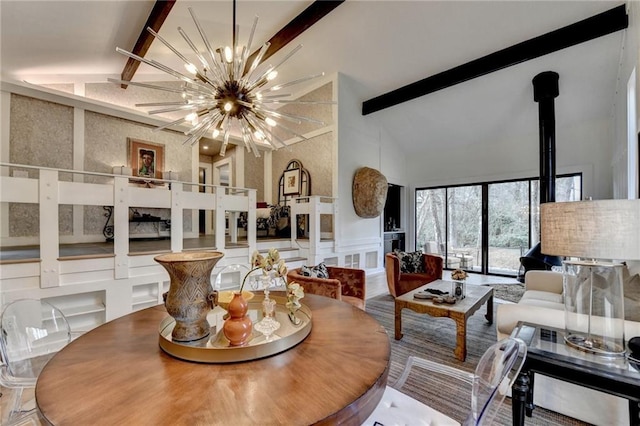 dining space featuring beamed ceiling, high vaulted ceiling, and an inviting chandelier