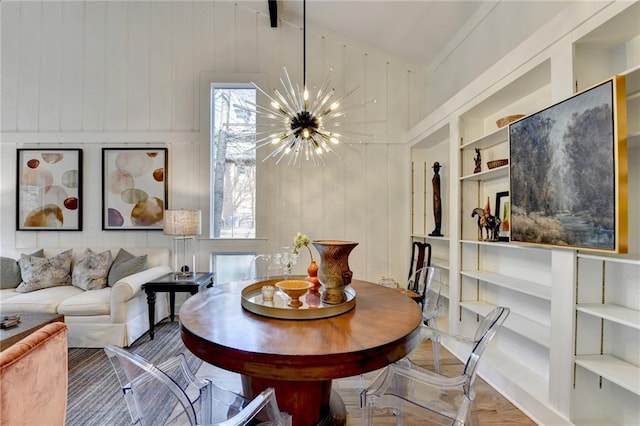 dining space featuring a healthy amount of sunlight, built in features, and a chandelier