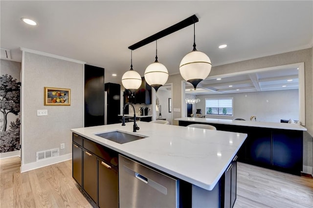 kitchen with sink, light stone countertops, an island with sink, decorative light fixtures, and stainless steel dishwasher