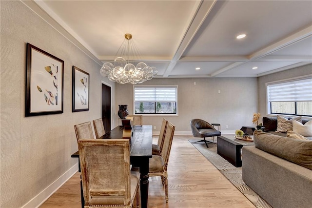 dining room featuring beamed ceiling, plenty of natural light, coffered ceiling, and light hardwood / wood-style floors