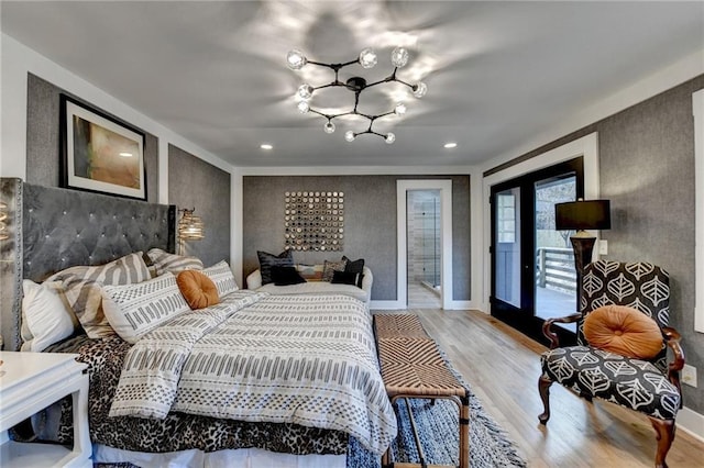 bedroom featuring wood-type flooring and access to outside