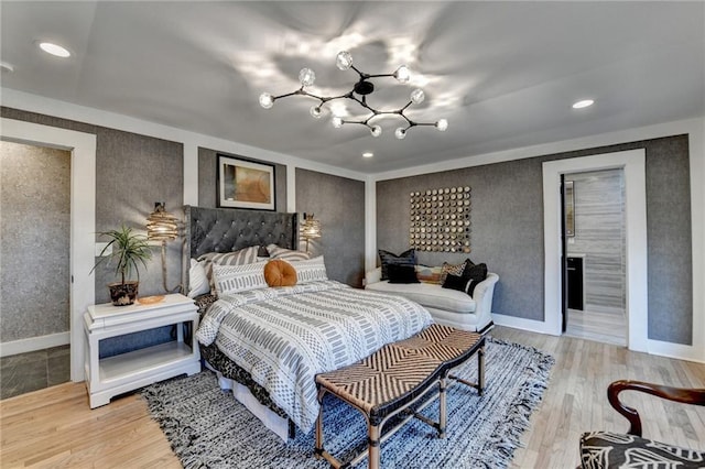 bedroom featuring a chandelier and light wood-type flooring