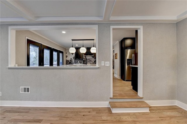 dining room with hardwood / wood-style flooring and beam ceiling