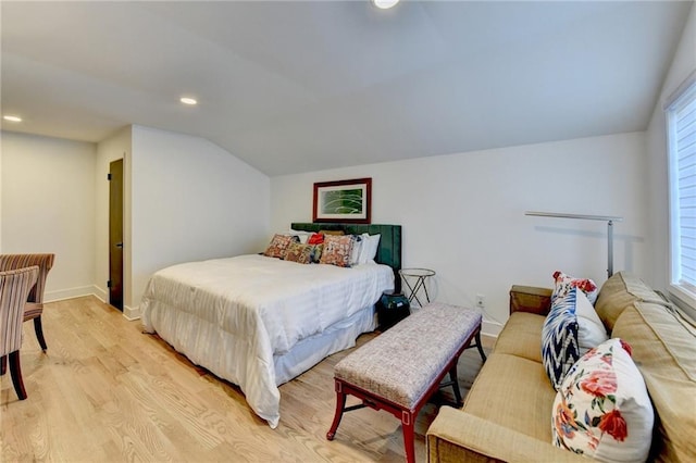 bedroom featuring lofted ceiling and light wood-type flooring