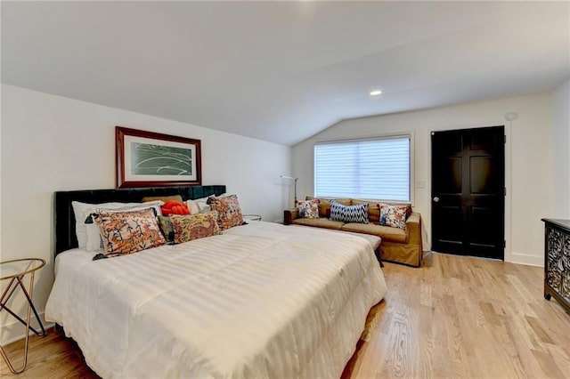 bedroom featuring vaulted ceiling and light hardwood / wood-style flooring