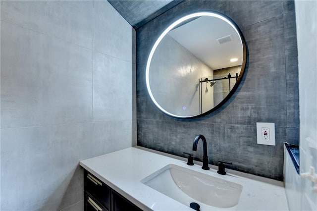 bathroom with tile walls and vanity