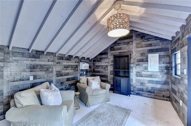 interior space with lofted ceiling with beams, concrete flooring, and wooden walls