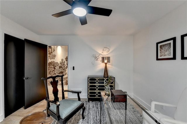 living area featuring ceiling fan