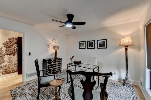 dining area with ceiling fan and light wood-type flooring