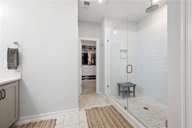 bathroom featuring vanity and a shower with door