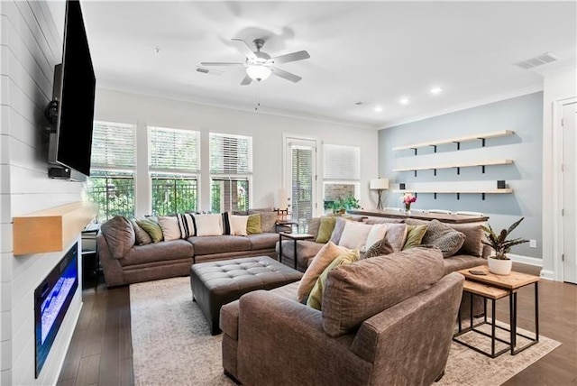 living room with crown molding, hardwood / wood-style floors, and ceiling fan