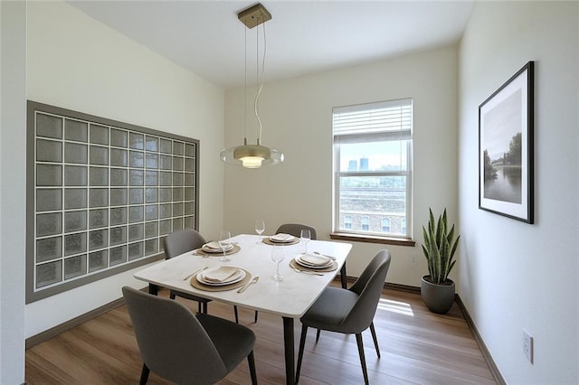 dining room featuring wood finished floors and baseboards
