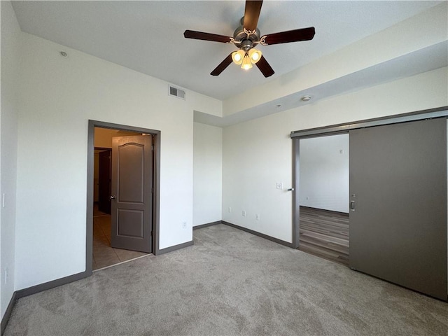 unfurnished bedroom featuring carpet flooring, baseboards, a closet, and ceiling fan