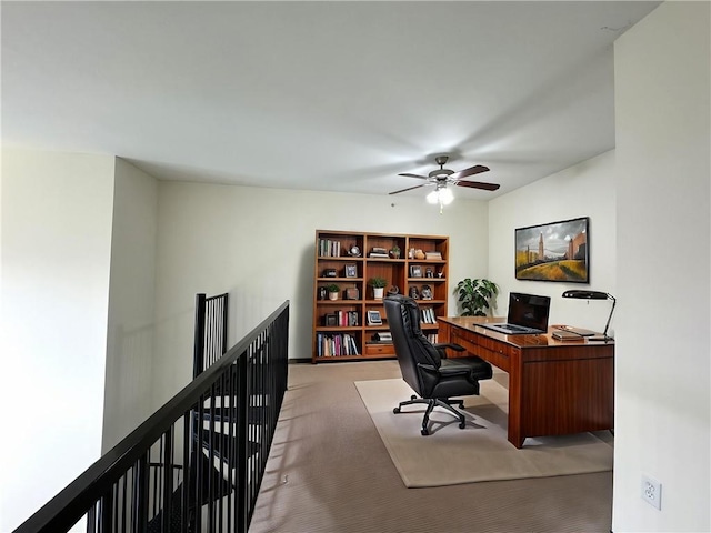 carpeted office featuring ceiling fan