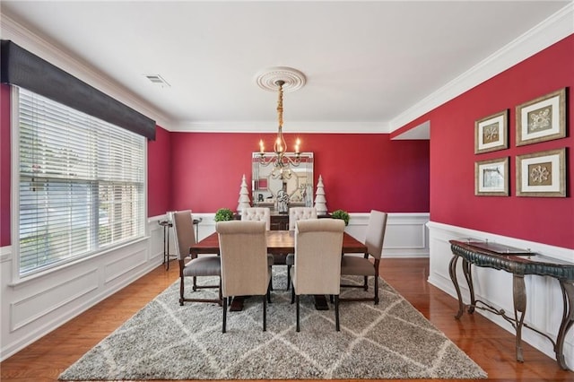 852 Van Briggle Path, Sugar Hill, GA 30518 - dining space featuring a chandelier, wainscoting, ornamental molding, wood finished floors, and a decorative wall