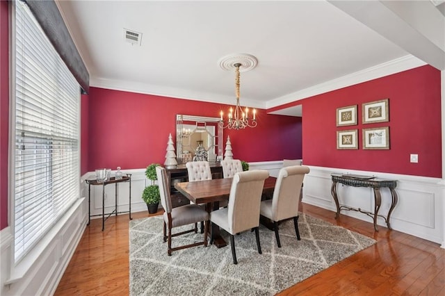 852 Van Briggle Path, Sugar Hill, GA 30518 - dining space featuring ornamental molding, a chandelier, wood finished floors, and wainscoting