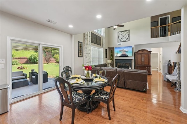 852 Van Briggle Path, Sugar Hill, GA 30518 - dining room with healthy amount of natural light, ceiling fan, a fireplace, light wood finished floors, and recessed lighting