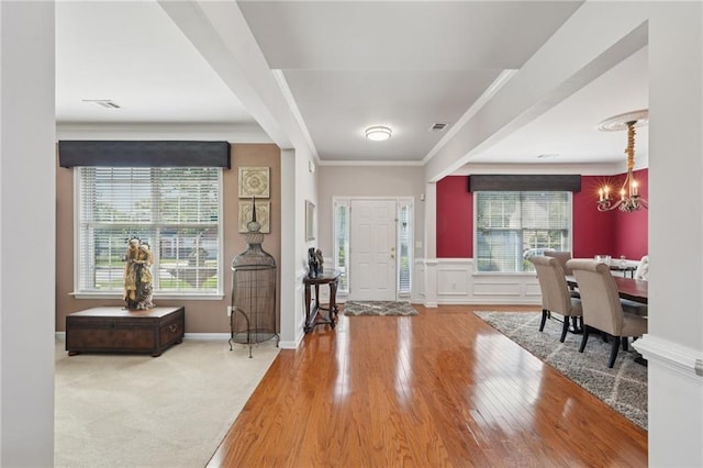 852 Van Briggle Path, Sugar Hill, GA 30518 - foyer featuring a chandelier, wood finished floors, plenty of natural light, and ornamental molding