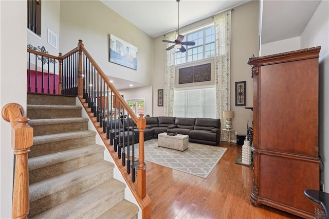 852 Van Briggle Path, Sugar Hill, GA 30518 - stairs featuring a towering ceiling, ceiling fan, and wood-type flooring
