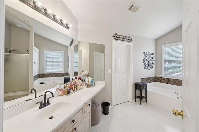 852 Van Briggle Path, Sugar Hill, GA 30518 - full bathroom featuring vaulted ceiling, a garden tub, plenty of natural light, vanity, and tile patterned flooring