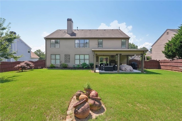 852 Van Briggle Path, Sugar Hill, GA 30518 - back of house featuring a fenced backyard, a patio, and a chimney
