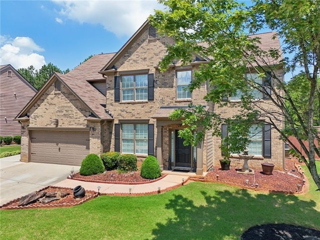 852 Van Briggle Path, Sugar Hill, GA 30518 - view of front of home featuring brick siding, a garage, driveway, and a front lawn