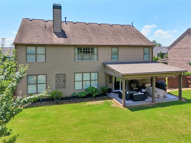 852 Van Briggle Path, Sugar Hill, GA 30518 - back of property featuring a chimney, a patio area, a lawn, and an outdoor living space