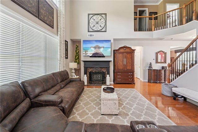 852 Van Briggle Path, Sugar Hill, GA 30518 - living area with wood finished floors, stairway, a high ceiling, a fireplace with flush hearth, and healthy amount of natural light