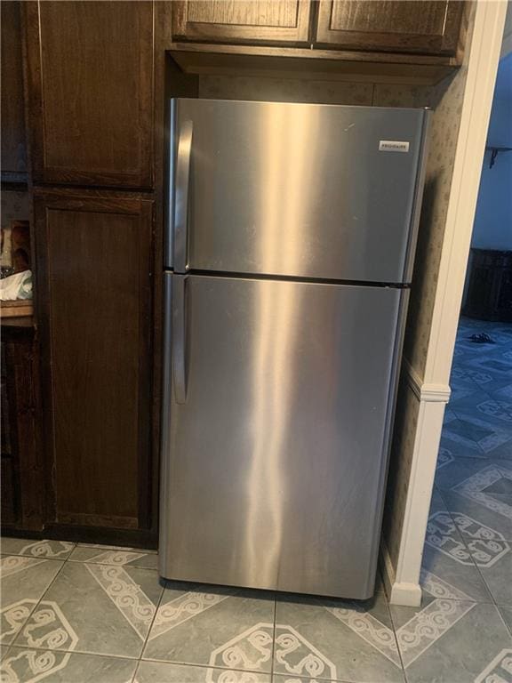 kitchen featuring dark brown cabinetry and stainless steel refrigerator