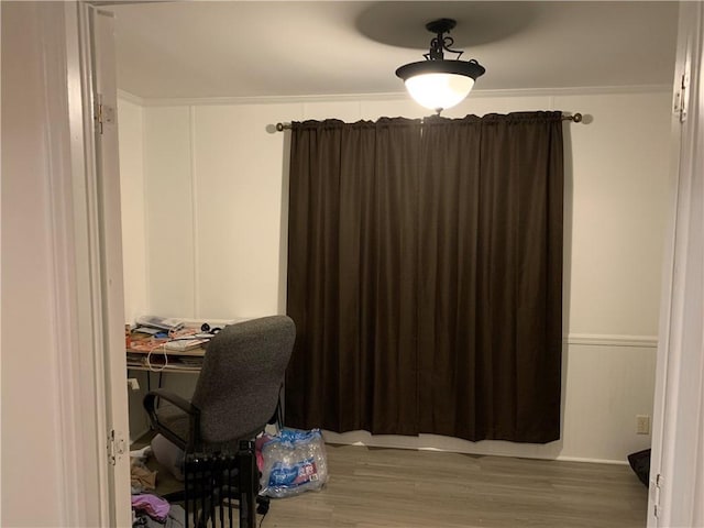 home office featuring wood-type flooring and ornamental molding