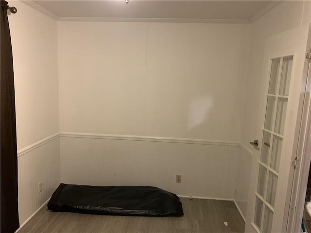 unfurnished bedroom with wood-type flooring and crown molding