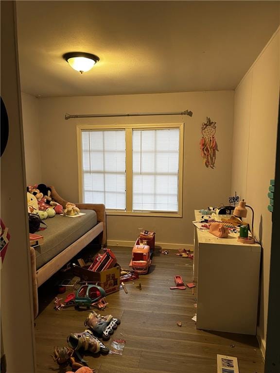 bedroom with dark hardwood / wood-style flooring