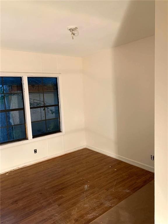 spare room featuring dark hardwood / wood-style floors