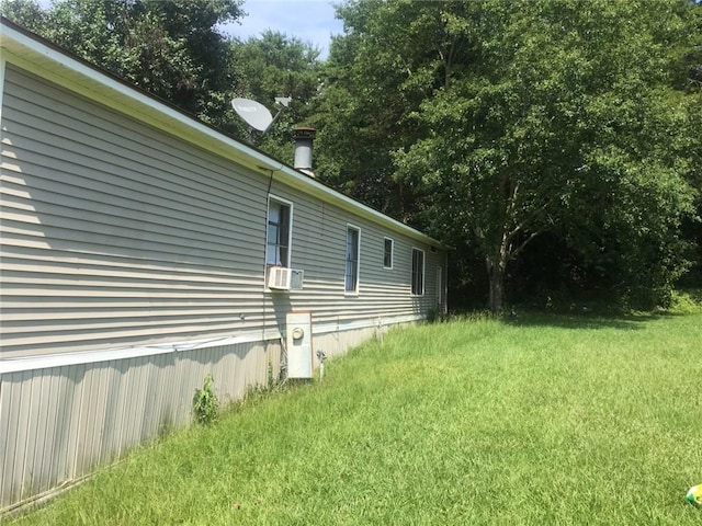 view of home's exterior featuring cooling unit and a yard