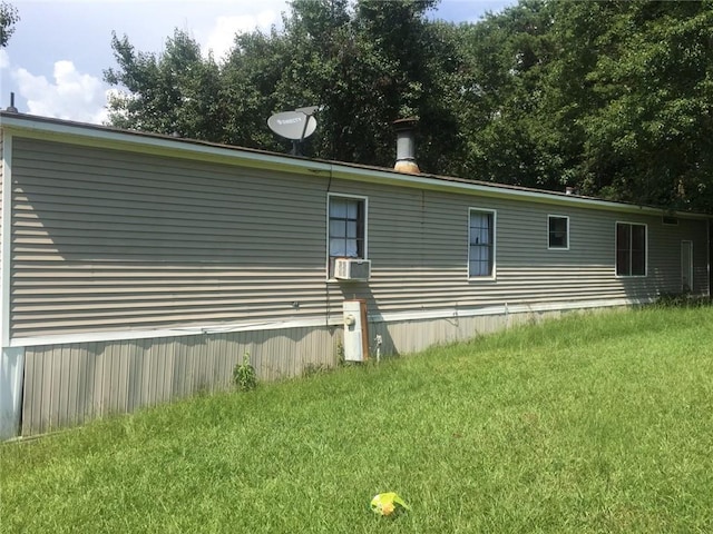 view of home's exterior with cooling unit and a lawn