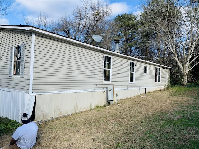 view of property exterior with a yard