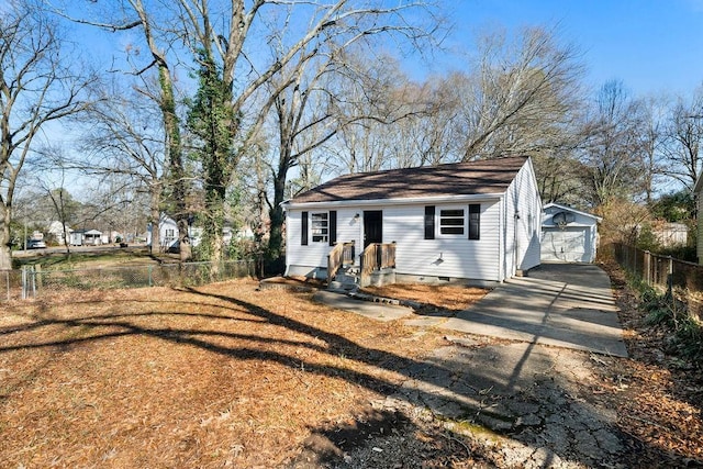 view of front of home featuring a garage and an outbuilding