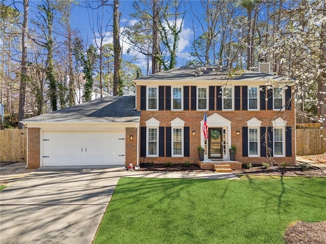 view of front of property featuring a garage, brick siding, and fence