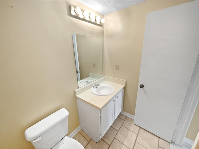 bathroom featuring vanity, toilet, and tile patterned flooring