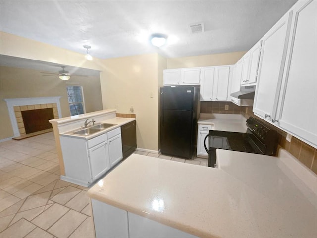 kitchen with sink, white cabinetry, kitchen peninsula, ceiling fan, and black appliances