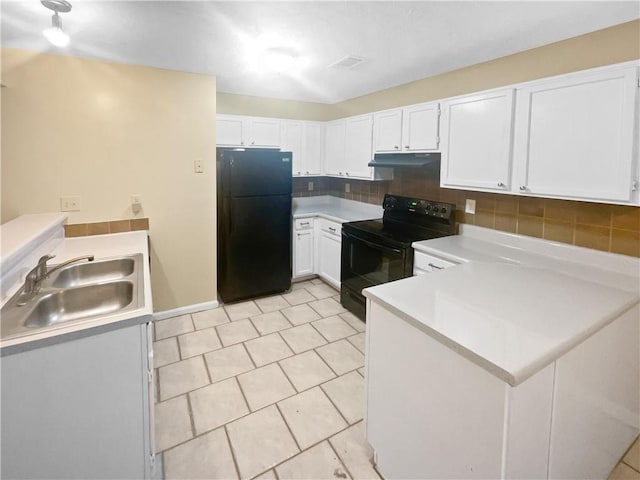 kitchen featuring sink, black appliances, light tile patterned floors, white cabinets, and backsplash